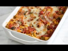 a casserole dish with cheese and vegetables in it