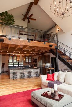 a living room filled with furniture and a ceiling fan