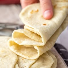 a stack of tortillas sitting on top of a plate