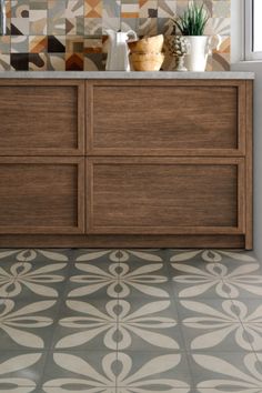 a bathroom with a tiled floor and wooden cabinets