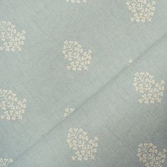 a blue and white fabric with small flowers on it