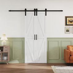 a living room filled with furniture and a sliding barn door in the middle of it