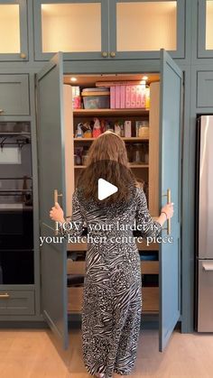 a woman standing in front of an open refrigerator