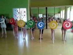 several people are standing around holding colorful lollipops