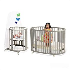 two baby cribs, one with a toddler in it and the other without