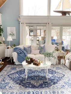 a living room filled with furniture and a blue rug