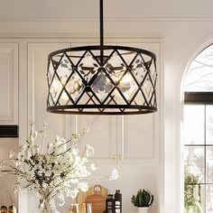 a chandelier hanging over a kitchen counter