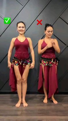 two women in red dresses standing next to each other with their hands on their hips