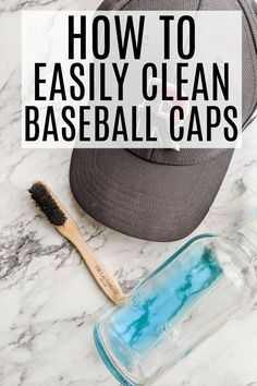 a baseball cap sitting on top of a white counter next to a blue ball and toothbrush