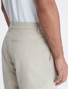 A sporty essential with simple, versatile styling. These shorts are designed with slip pockets at both sides and welt pockets at the back. Features a Calvin Klein logo detail near the back pocket.  Material: 100% Polyester. Back Pocket, Both Sides, Welt Pockets, Welt Pocket, Calvin Klein