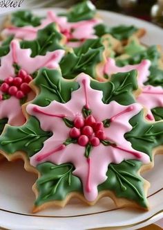 decorated cookies on a plate with holly leaves