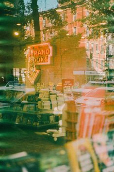 a store window with cars parked in front of it and a sign that reads brand books