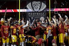 the football team is celebrating with their trophy