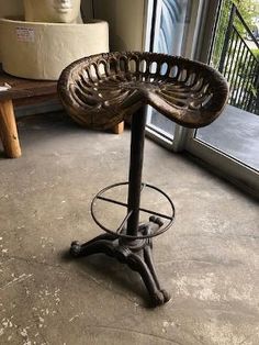 a chair sitting on top of a wooden floor next to a glass door and window