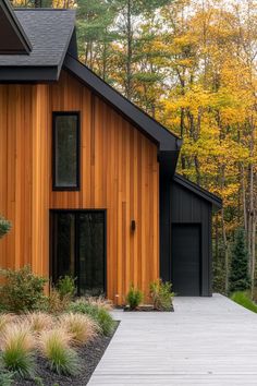 a house that is made out of wood and has black shingles on the roof