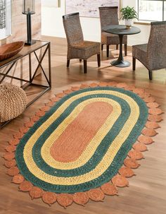 a living room filled with furniture and rugs on top of hard wood flooring