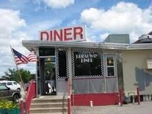 a diner with an american flag in front of it