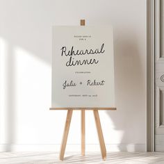 an easel with a sign on it in front of a white wall and door