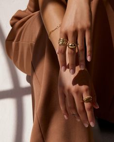 Smooth and futuristic, our 14k gold Dome Ring was created to make a statement while remaining compact enough to stack with other rings alike. Its shiny, polished surface offers a chunky presence and makes a statement solo but looks equally as prodigious when layered with a handful of rings. The Large Dome Ring has been hollowed out for ultra-lightness and measures 10mm at its widest, tapering to 3.5mm in the back for comfortable wear. Made to order. Please allow one week for production. Dome Ring Stack, Holiday Jewelry Campaign, Jewelry Model Poses, Fashion Jewelry Photography, Rings Styling, Ring Photoshoot, Gold Dome Ring, Jewellery Photography Inspiration, Jewelry Product Shots