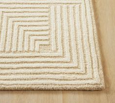 a white rug on top of a wooden floor