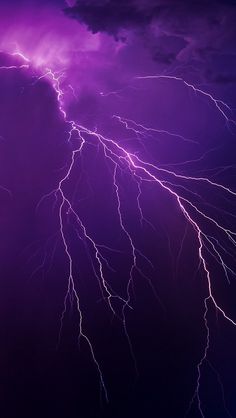 purple lightning strikes in the night sky