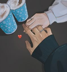 two people holding hands over a table with cups of coffee and hearts on the table