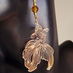 "Enjoy my \"Golden Fantail Filigree Earrings\" . These earrings are stunning  and are accented with a bronze Austrian Crystal . Ear wire is gold plated sterling silver. The shimmering of the filigree design create a beautiful aura that symbolizes the metallic scales of the fantail. The fantail goldfish symbolizes good luck and fortune.  Wear them with any ensemble and at any occasion.  Thank you for shopping at CraftsRU!" Gold Brass Crystal Earrings For Party, Elegant Nickel-free Copper Wire Earrings, Bohemian Gold Crystal Earrings As Gift, Bohemian Gold Crystal Earrings For Gift, Gold Wire-wrapped Crystal Earrings, Gold Wire Wrapped Metal Earrings, Gold-plated Wire Wrapped Earrings, Gold Metal Earrings With Wire Wrapped Detail, Gold Plated Wire Wrapped Gold Earrings