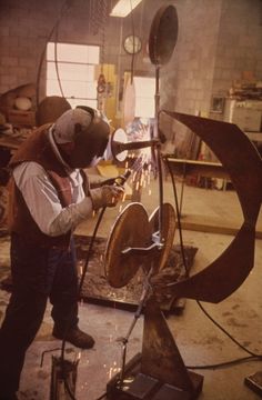 a man working on an object in a factory