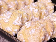 some powdered sugar cookies sitting in a pan