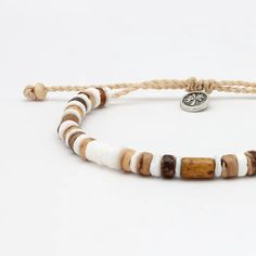 Introducing the Nusa Lembongan Wood Bead Bracelet! Inspired by the coconut trees surrounding Nusa Lembongan in Bali! Designed as a surf-inspired addition to your anklet stack, this anklet will keep a piece of the beach with you everywhere you go! Made with dyed coconut wood, natural shell and a wax polyester cord. Measures approx. 17cm with a 7cm sliding knot extension. Handmade in Bali. Biodegradable or recyclable packaging. Heishi Beads Jewelry With Sliding Knot For Beach, Adjustable Wooden Beads Friendship Bracelets For Beach, Beach Jewelry With Heishi Beads And Sliding Knot, Adjustable Wooden Beads Friendship Bracelets, Casual Brown Beaded Bracelets For Vacation, Hippie Brown Friendship Bracelets For Beach, Brown Sliding Knot Friendship Bracelets For Beach, Adjustable Tropical Bracelets For Vacation, Adjustable Tropical Style Bracelets For Vacation