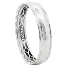 a white gold wedding ring with intricate engraving