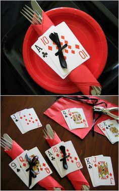 the table is set with playing cards and forks