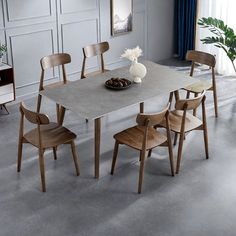 a dining table with four chairs around it