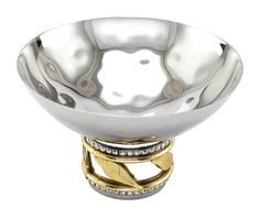 a large silver bowl with gold accents on the bottom and sides, sitting in front of a white background