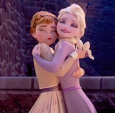 two dolls are hugging each other in front of a castle