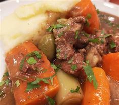 a white plate topped with meat and vegetables