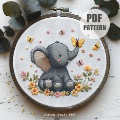 an elephant with flowers and butterflies on it's back is shown in the hoop