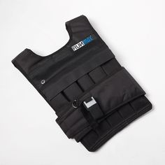 a black vest that is on top of a white surface