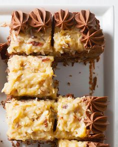 four pieces of cake on a white plate