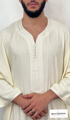 Mens Moroccan Thobe - Cream |djellaba, Jubbah, Beautiful quality with a lovely soft feel and texture.  Beautiful quality with a lovely soft feel and texture. A luxurious and sophisticated variation of the traditional North African garment. Crafted from high-quality linen, this garment combines the timeless elegance of a kaftan with the breathability and comfort of premium linen fabric. The standout feature of this thobe is the use of premium linen, a natural and lightweight fabric that is highly breathable and comfortable.  The design of the thobe retains the classic elements, with a long, loose-fitting silhouette that drapes gracefully from the shoulders to the ankles. Brand new, with original personal wrapping. We are known to many for our extensive Moroccan clothing collection. Colours: Traditional Beige Long Sleeve Kaftan, Traditional Long Sleeve Beige Kaftan, Beige Long Sleeve Kaftan For Eid, Cream Long Sleeve Thobe For Eid, Long Sleeve Cream Thobe For Eid, Beige Long Thobe For Eid, Beige Dabka Kaftan For Eid, Bohemian Long Sleeve Agbada For Eid, Festive Beige Long Sleeve Kaftan