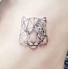 a tiger tattoo on the side of a woman's stomach