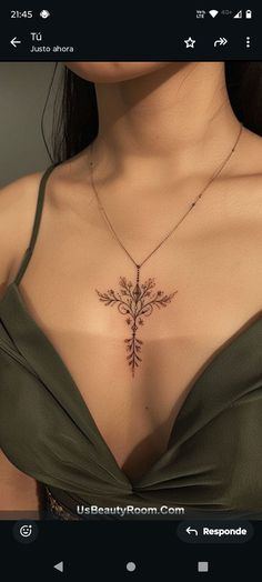 a woman's chest with a cross tattoo on her chest and an arrow in the middle