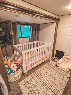 a baby crib in the corner of a room with a rug on the floor