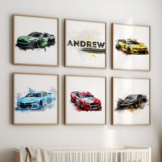 four framed cars are hanging on the wall above a crib