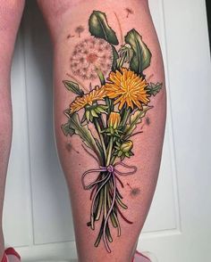 a woman's legs with flowers and leaves painted on them, all around her