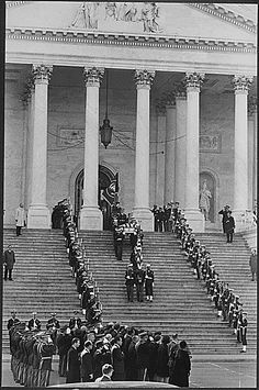 an old black and white photo of people in front of the capitol building with columns