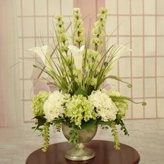 a vase filled with white flowers on top of a table