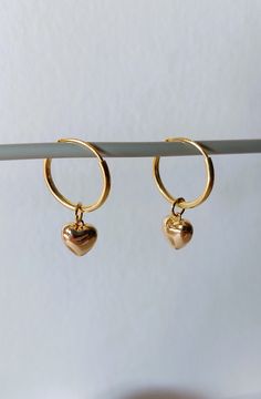 925 sterling silver gold plated hoop earrings, 14mm diameter, with an 18k gold plated heart. Length of the earring is 25 mm. The 18 carat gold filling is approx. 100 times thicker than with simple gold plating. The gold layer is mechanically bonded to the brass base material Goldfilled is resistant to abrasion under normal use. Small inclusions, color deviations and irregularities on the pearls or on the metals are part of the peculiarity of the materials. If you have special requests, want unusual pieces of jewelry, please feel free to contact me. More beautiful pieces of jewelry can be found here: https://www.etsy.com/de/shop/MerlesSchmuckArt Hoop Jewelry With Heart Charm For Anniversary, Heart Charm Small Hoop Jewelry For Anniversary, Small Hoop Jewelry With Heart Charm For Anniversary, Small Hoop Tarnish-resistant Jewelry For Valentine's Day, Small Hoop Tarnish Resistant Jewelry For Valentine's Day, Dainty Sterling Silver Hoop Earrings With Heart Charm, Dainty Heart-shaped Tarnish-resistant Huggie Earrings, Valentine's Day Tarnish-resistant Small Hoop Jewelry, Yellow Gold Hoop Earrings For Valentine's Day