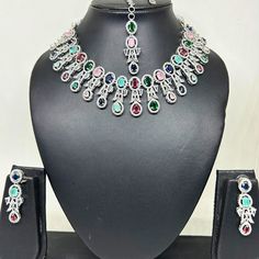 Elevate your style and celebrate the timeless beauty of Indian tradition with this exquisite Premium AD Necklace Set. This enchanting jewelry ensemble is a perfect blend of traditional and contemporary design, making it a stunning addition to any special occasion or a thoughtful gift for a loved one. Product Details: Premium AD Necklace: Our meticulously crafted necklace features a stunning pendant adorned with American Diamond (AD) crystals, adding a touch of elegance and charm. The necklace sh Formal Multicolor Hand Set Bridal Necklace, Festive Silver Jewelry Sets With Elegant Design, Silver Bridal Necklace With Elegant Design For Festivals, Festival Bridal Necklace With Elegant Design In Silver, Festive Silver Bridal Necklace With Elegant Design, Festive Silver Jewelry Sets For Anniversary, Silver Bridal Sets With Elegant Design For Festive, Elegant Multicolor Hand Set Bridal Sets, Elegant Multicolor Bridal Sets For Festivals