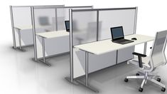 an office cubicle with two desks and a laptop